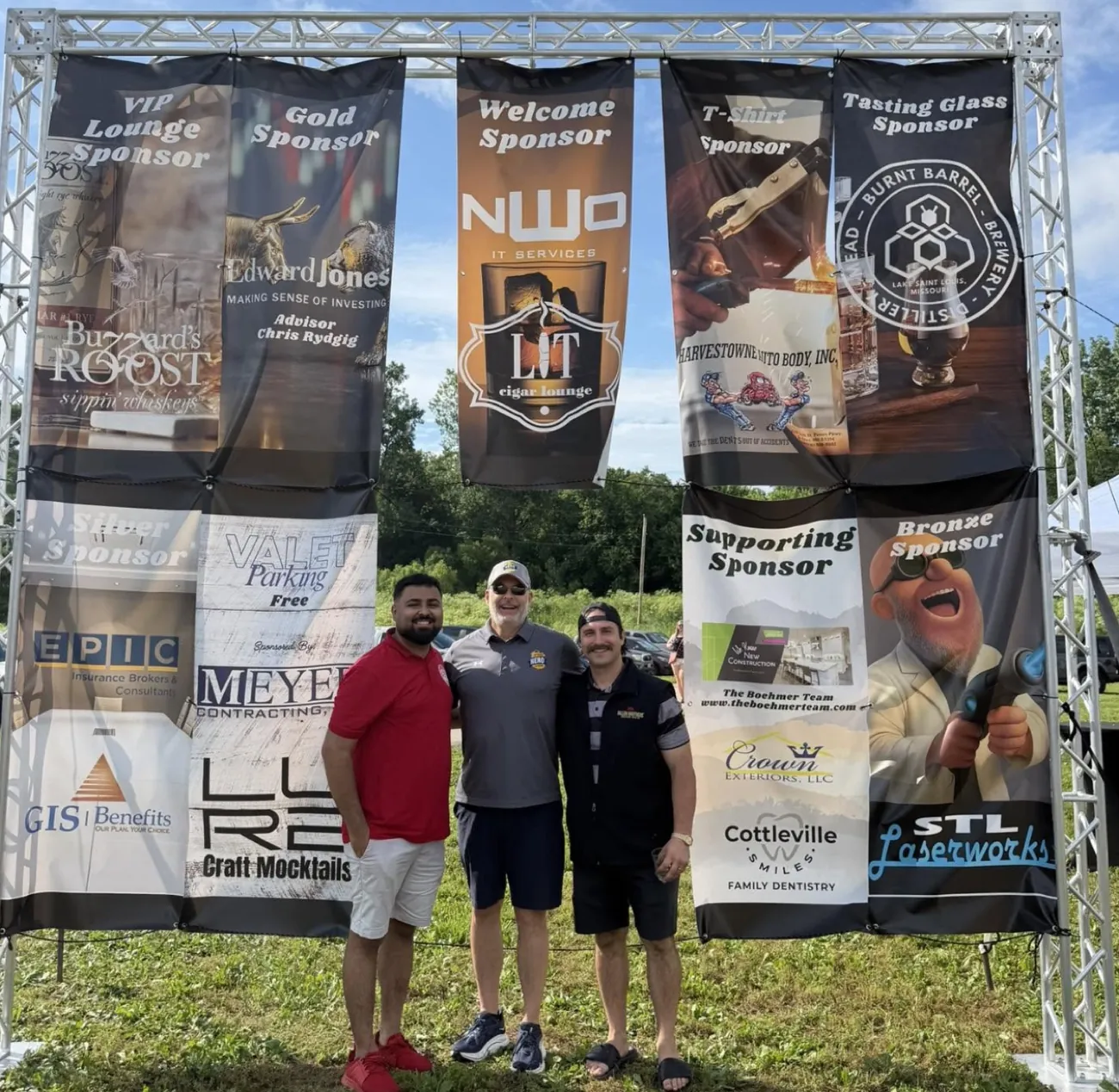 Guests standing beneath sponsor banners at the 1st Annual MO Spirit Festival